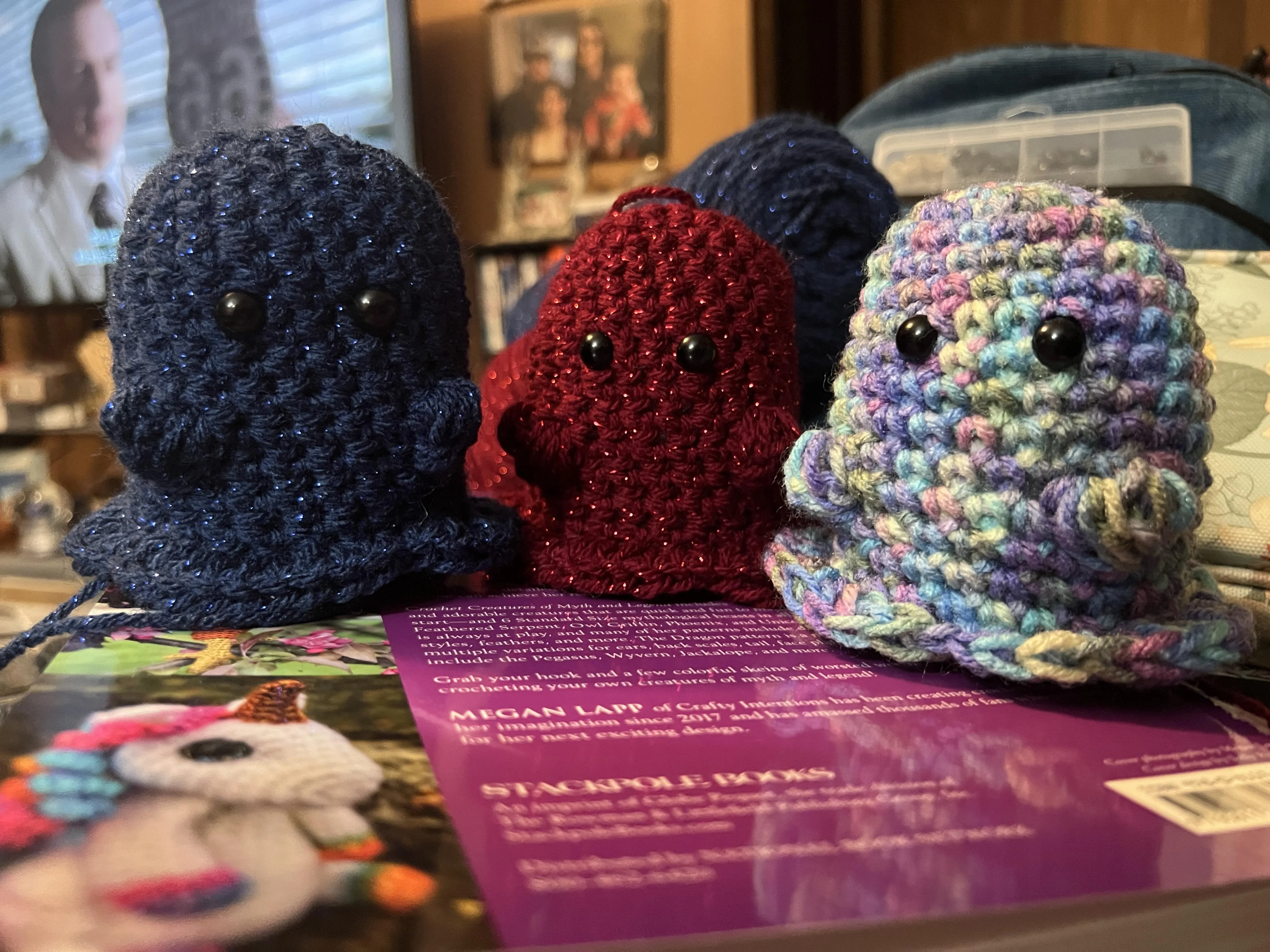 3 crochet ghosts, red, blue, and white